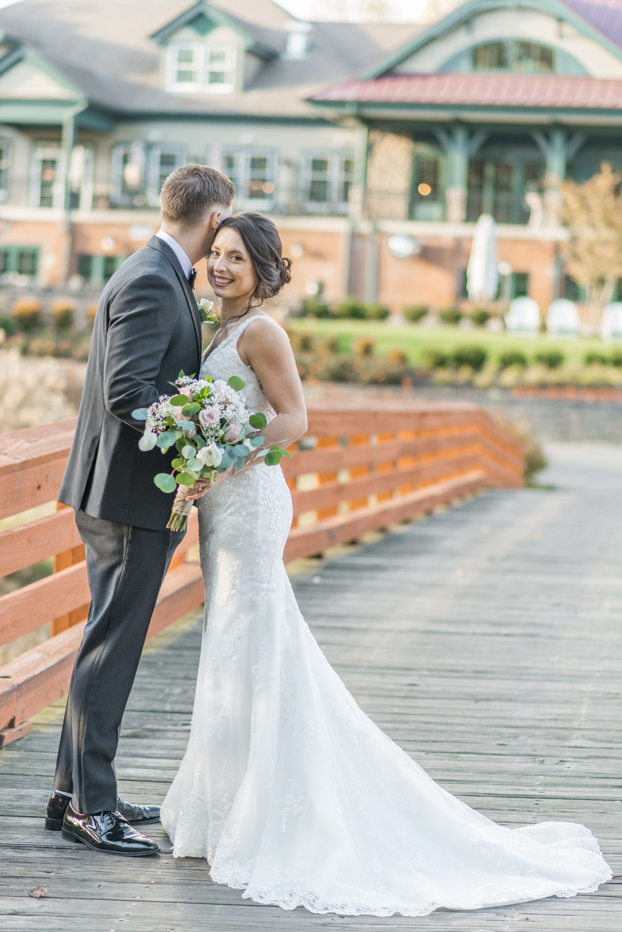 Bride and Groom posing in front of The Golf Club at South River